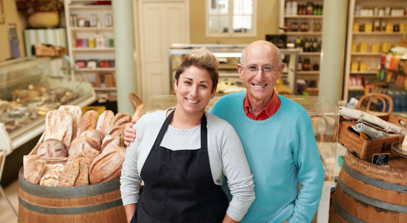 father and daughter business owners standing in bakery