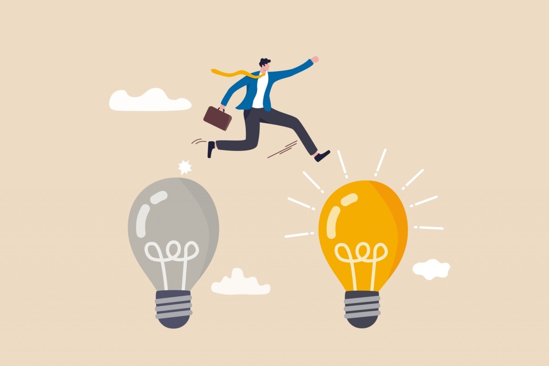 a cartoon person jumps from an unlit lightbulb to a lit one