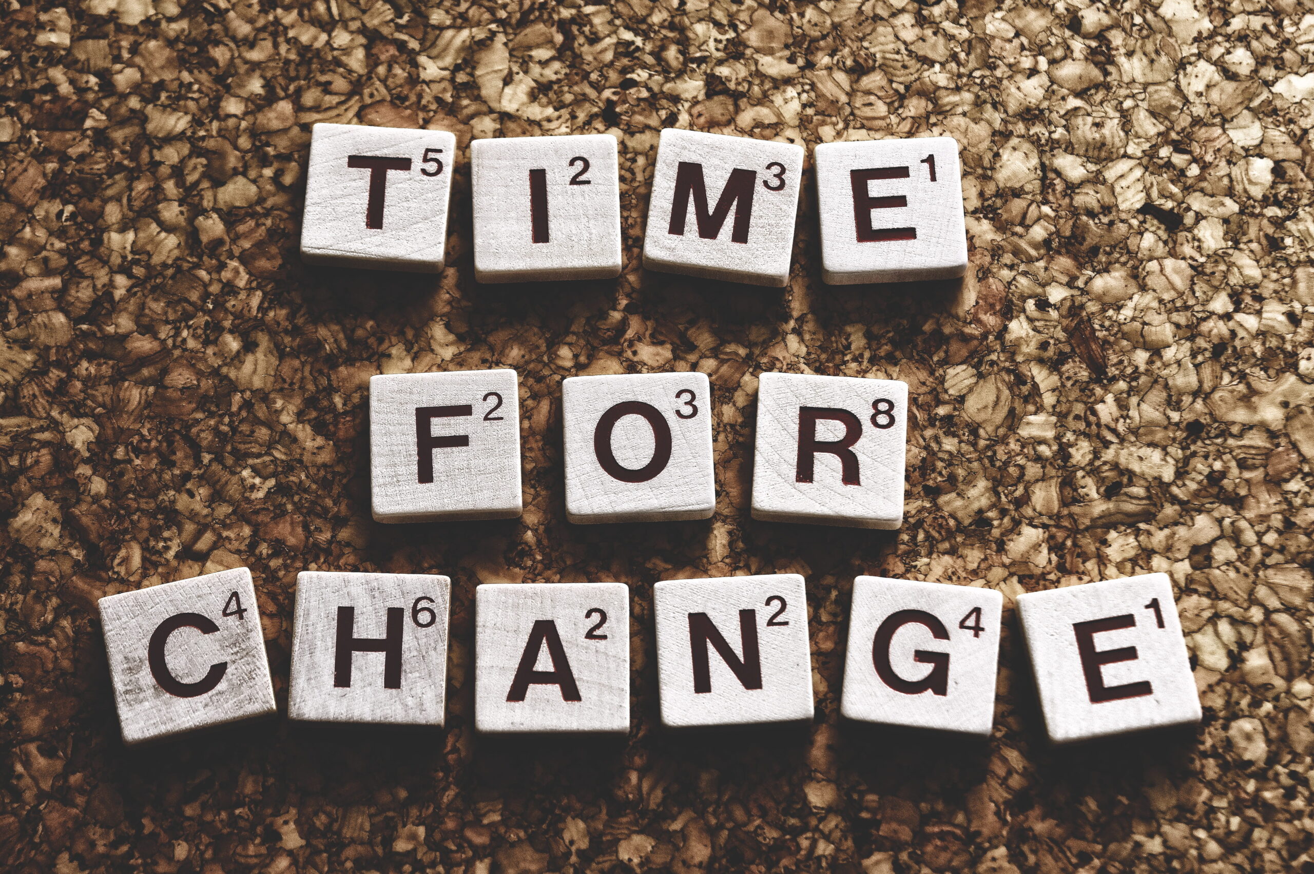 small wooden tiles spell out "time for change"